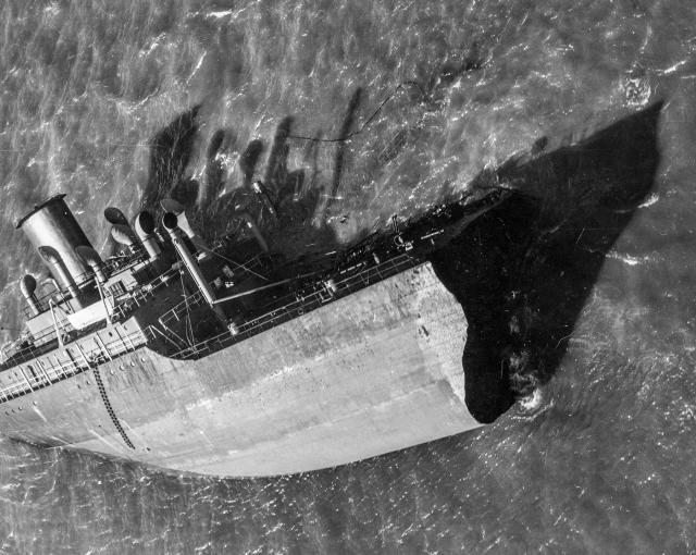 The Pendleton’s stern eventually grounded on a sandbar off Monomoy Island, south of Chatham. Her Jacob’s ladder is visible as a dark line on the hull. The stern is now underwater. 