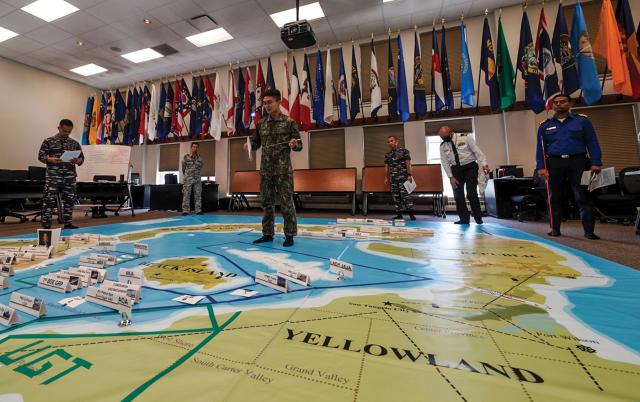 Students conduct a wargaming exercise at the Naval War College (NWC). The NWC curriculum should be modeled after Admiral Sims’ use of theater-level games to develop character and command skills, and teach officers to fight outside their warfare specialties.