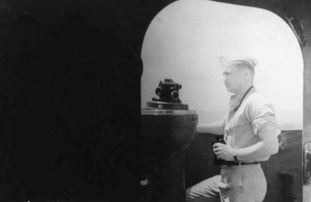 Ensign Jens Hansen standing on the bridge of the USS Hornet (CV-12)