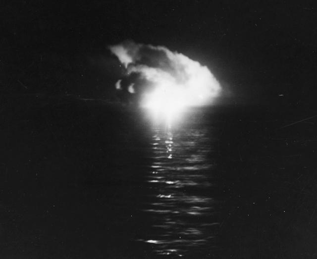 A Japanese ship burns during the battle, as captured in this photograph taken from the USS Nicholas. When fires like these disappeared, it was often taken as evidence that the burning ship had sunk. NAVAL HISTORY AND HERITAGE COMMAND.