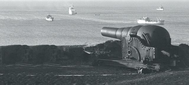 Amphibious ships assemble under the 19th-century guns of Ascension Island.