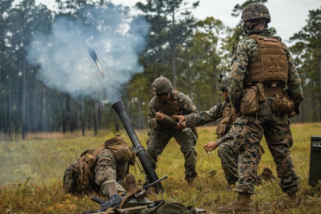 Marines fire an M252 81-mm mortar system during a battalion field exercise at Camp Lejeune, North Carolina, in May. The M252 can reach targets at more than double the range of the Mk 38 cannon, and precision-guided rounds for mortars cost a fraction of the price of missiles.