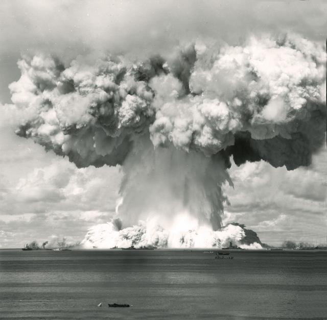 The 25 July 1946 “Baker” test during Operation Crossroads detonated a “Fat Man” nuclear bomb underwater in the midst of an anchored fleet of retired and captured ships. Eight were sunk, others were critically damaged, and all were rendered fatal to their (hypothetical) crews by contamination with radioactive spray from the explosion.