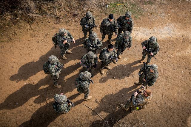 A U.S. Marine from speaks with Republic of Korea (ROK) Marines from the 1st ROK Marine Division, during Warrior Shield 24 in South Korea in March. The formal combined command of U.S. and ROK forces offers a good model for potentially similar bilateral and multilateral commands in the first island chain.  