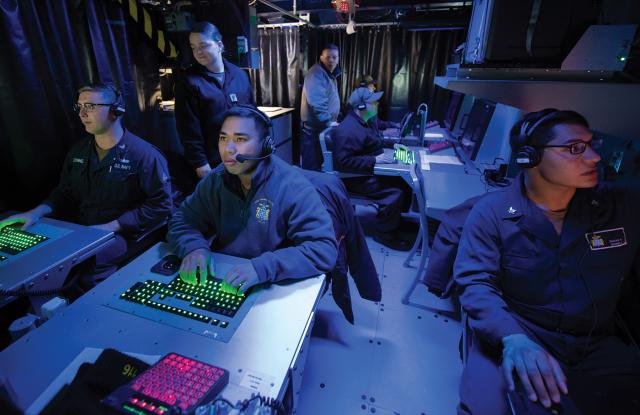 Navy operations specialists working inside a destroyer command information center share real-time data and technology during exercises. This technological know-how and experience in high-pressure situations can be an asset at many civilian jobs, if sailors know how to craft a resume.
