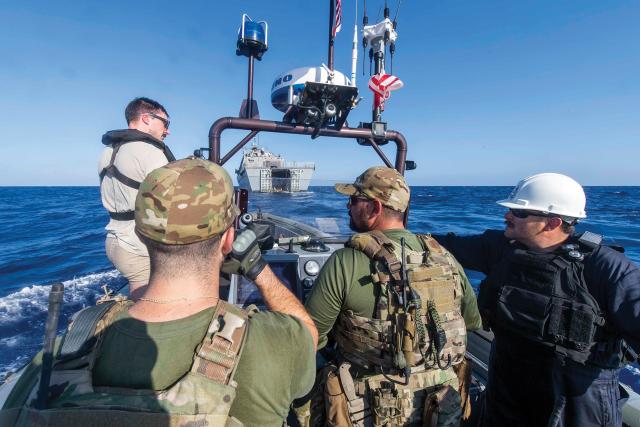 Sailors and Coast Guardsmen assigned to the littoral combat ship USS Detroit (LCS-7) conduct a rigid-hull inflatable boat operation in the Caribbean Sea in March. To be more effective in supporting homeland defense, the Navy IW community must be more integrated with the Coast Guard and other agencies with law enforcement missions and authorities.