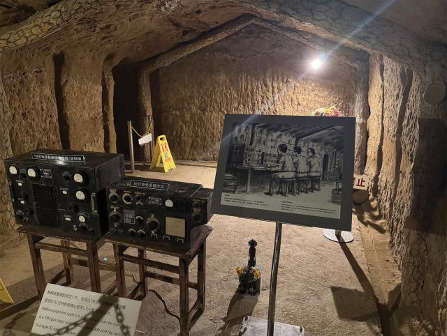 The former communications room in the tunnel complex, with period radios and an artist’s sketch of how it may have looked during the battle.