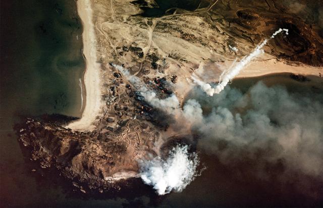 Captured in a helicopter photo, a white phosphorus shell from the heavy cruiser USS Saint Paul explodes in the target area during a bombardment of enemy installations at Wonsan, 20 April 1951. One year and one day later, the Saint Paul would suffer a powder fire and explosion in the forward 8-inch turrent that killed 30 men.