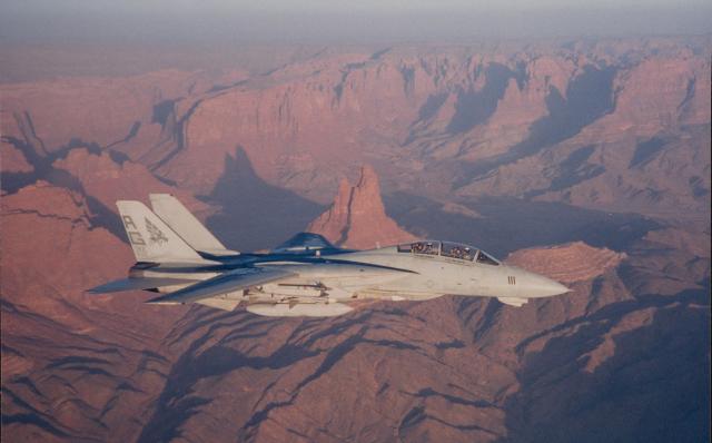 An F-14A+ Tomcat of Strike Fighter Squadron 143 off the USS Dwight D. Eisenhower  (CVN-69) is the first to fly over Saudi Arabia during Operation Desert Shield.