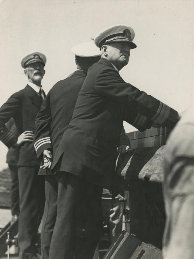 Rear Admirals Joseph “Bull” Reeves and William A. Moffett standing at a wall
