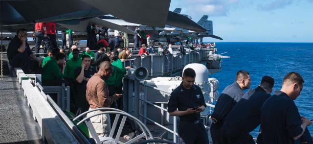 Sailors during a cell phone–approved period on board the USS Ronald Reagan 