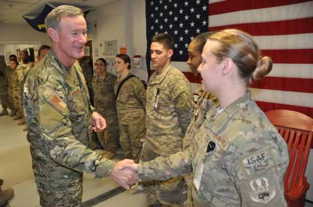 Admiral McRaven meets a hospital staff member from the Heathe N. Craig Joint Theater Hospital during a 2013 visit to Bagram Air Field, Afghanistan.