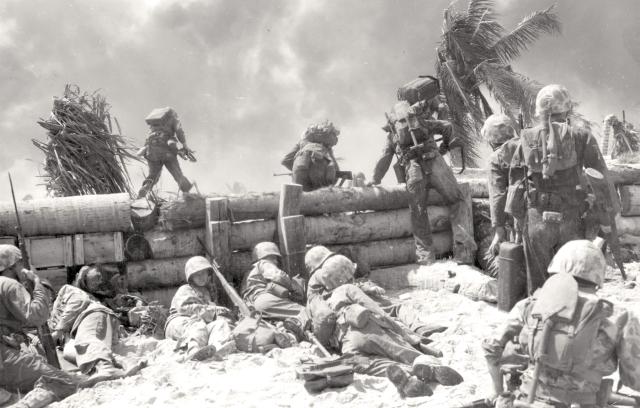 Marines move out from the beachhead toward the smoke-shrouded Japanese airstrip.