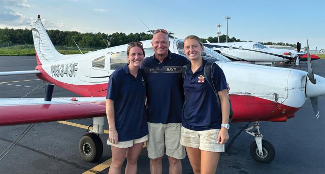 Captain Josh “Flipper” Sager, the Naval Academy’s senior aviator and a civilian CFI, congratulates two members of the class of 2024, then–Midshipmen Katie Golbranson (left) and Leelee Denton (right), after completing PFP in August 2023. Both were selected for Navy Pilot and will report to Pensacola this year. 