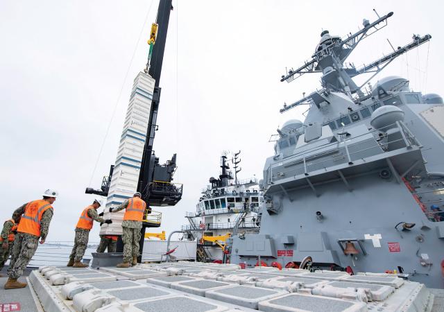 Sailors guide training ordnance into a destroyer’s forward vertical-launch system. Concerns about the number of vertical-launch cells the U.S. Navy could bring to a maritime conflict with China will be moot if the service does not have enough missiles to fit and refill them.