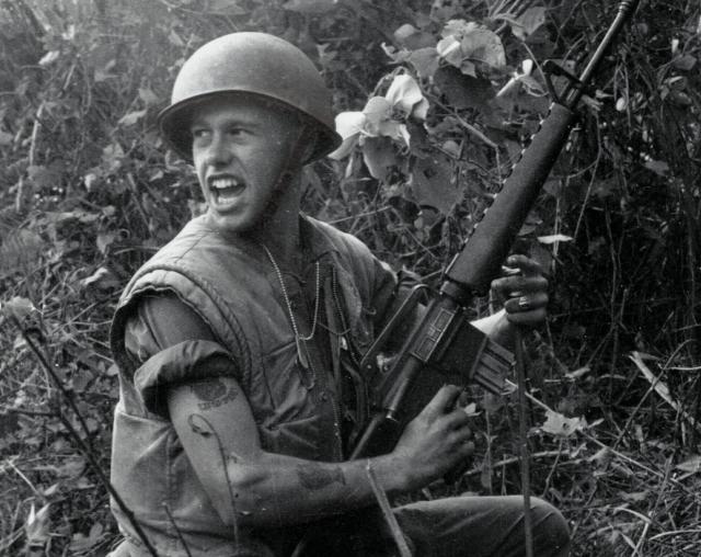 A squad leader from 1st Battalion, 7th Marine Regiment, yells for his men to move up during a fight near Da Nang in July 1967. Military leaders on both sides recognized that a stalemate had formed that year, and each developed plans to break it through invasion.