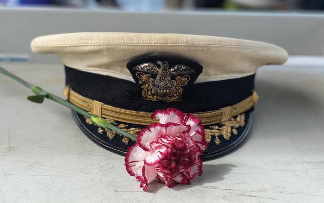Traveling to the waters above a famous U.S. submarine wreck, the family of the commanding officer brought his hat to honor the pilgrimage.