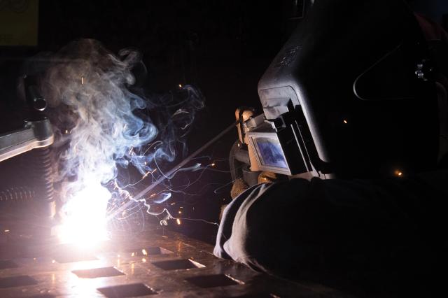 A welder works on plates on board the Dwight D. Eisenhower (CVN-69) in March 2020.