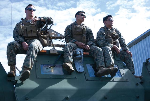 Marines pose on top of an M142 high-mobility artillery rocket system (HiMARS) launcher during exercise Talisman Saber 19 in Australia. Force Design 2030 proposes tripling the number of rocket artillery batteries to 21.