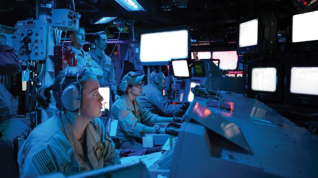 Sailors and officers on board the guided-missile destroyer USS Carney (DDG-64) stand watch in the ship’s combat information center during an operation to defeat a combination of Houthi missiles and unmanned aerial vehicles. Operating in the Red Sea before Operation Prosperity Guardian and Operation Poseidon Archer began, on 19 October 2023, the Carney intercepted 15 drones and four cruise missiles launched at Israel by the Houthis in a 10-hour period. 