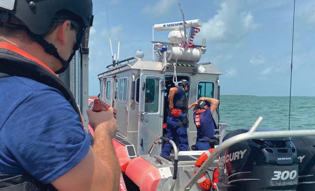 A Coast Guard Station Islamorada law enforcement officer covers a boarding team member during a training exercise. Assessment teams from the Coast Guard’s Maritime Law Enforcement Academy evaluate operational units’ physical techniques and mock boardings, but they do not always examine civil penalties and criminal case outcomes, exacerbating the larger problem.