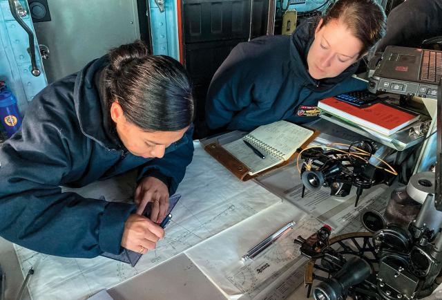 The coauthor, right, and one of her quartermasters on board the USS Essex (LHD-2) plot a course in the ship’s pilothouse. To ensure the bridge watchstanders could keep a precise and continuous paper plot, Lieutenant Commander Stanton required practice plots during both deployment transoceanic transits (San Diego to Guam, then Japan to Oahu).