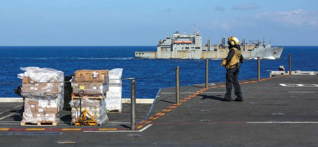 The MSC dry cargo and ammunition ship USNS Alan Shepard (T-AKE-3) sails near the USS Abraham Lincoln (CVN-72) during a replenishment at sea.
