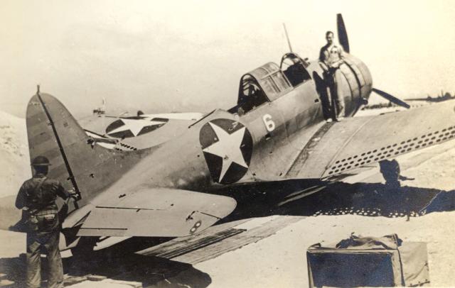 At Midway, First Lieutenant Daniel Iverson stands on a wing of his shot-up SBD-2 Dauntless, one of MAG-22’s 46 aircraft losses in the Battle of Midway. Later repaired in the United States, the restored SBD is now an exhibit at the National Naval Aviation Museum in Pensacola, Florida. 