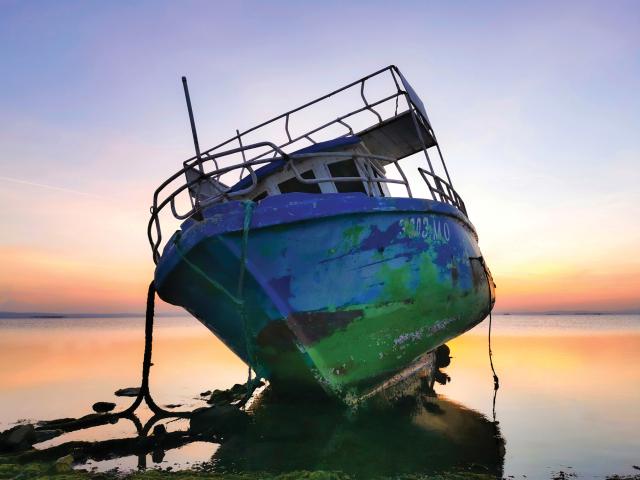 Abandoned boat Marwen Louafi  An abandoned boat in the lake at sunset,  Menzel Jemil, Tunisia.