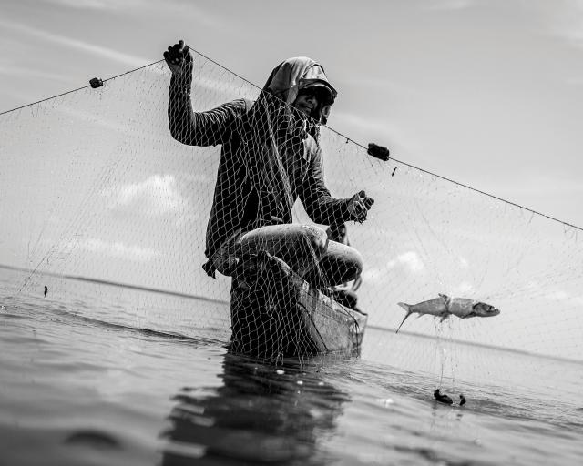 The Fisherman CAPT Javier Arcenillas, Spanish Marine Infantry (Ret.) Fisherman in Nueva Venecia, Colombia, works on a net.