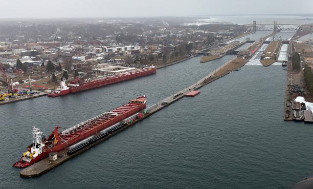 Tow vessels and their barges prepare to pass through the Soo Locks