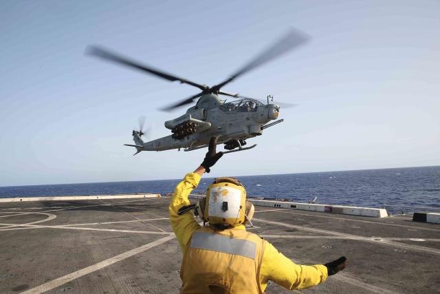 An AH-1Z Cobra helicopter attached to the 15th Marine Expeditionary Unit prepares to land on board the USS San Diego (LPD-22).