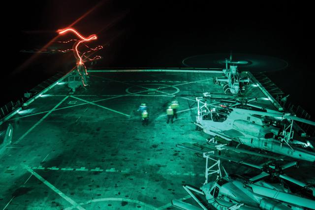 Flight-deck operations are inherently dangerous, especially at night with multiple aircraft operating at once. Aircraft returning to the deck with ordnance are required to fly the “alpha approach,” which trims the margins for error even further. Special flight deck markings would help limit that risk. Here, aircraft from the 15th Marine Expeditionary Unit operate from the USS San Diego (LPD-22). 