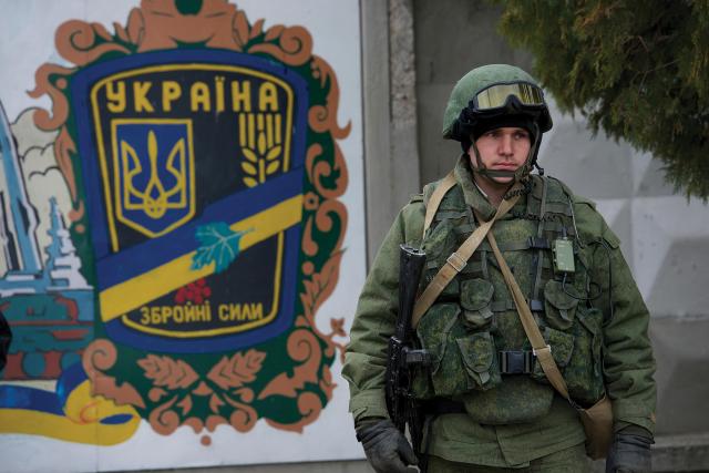 A Russian soldier in a uniform without national or unit insignia stands guard outside a military base in Crimea in 2014. Russia’s annexation of Crimea demonstrated that a relatively small number of soldiers could achieve significant results when paired with the confusion wrought by cyber forces.