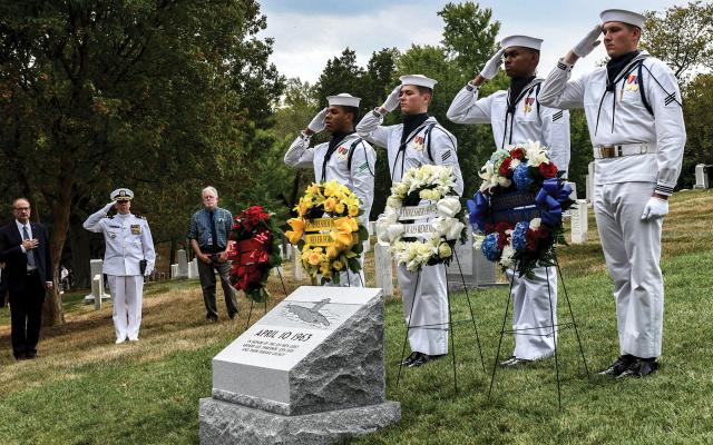 Sailors salute as “Taps” is played during a wreath-laying ceremony at the USS Thresher commemorative monument in Arlington National Cemetery