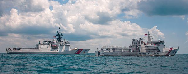 The USCGC Munro (WMSL-755) steams in formation with the Indonesia Coast Guard vessel Pulau Dana in the Singapore Strait. Task organization would include maritime law enforcement detachments led by host-nation security forces and augmented with U.S. Marines, Coast Guardsmen, and sailors. Host-nation security forces would make the actual arrests. Host-nation white hulls alongside U.S. Coast Guard cutters should be the most visible maritime enforcement presence.