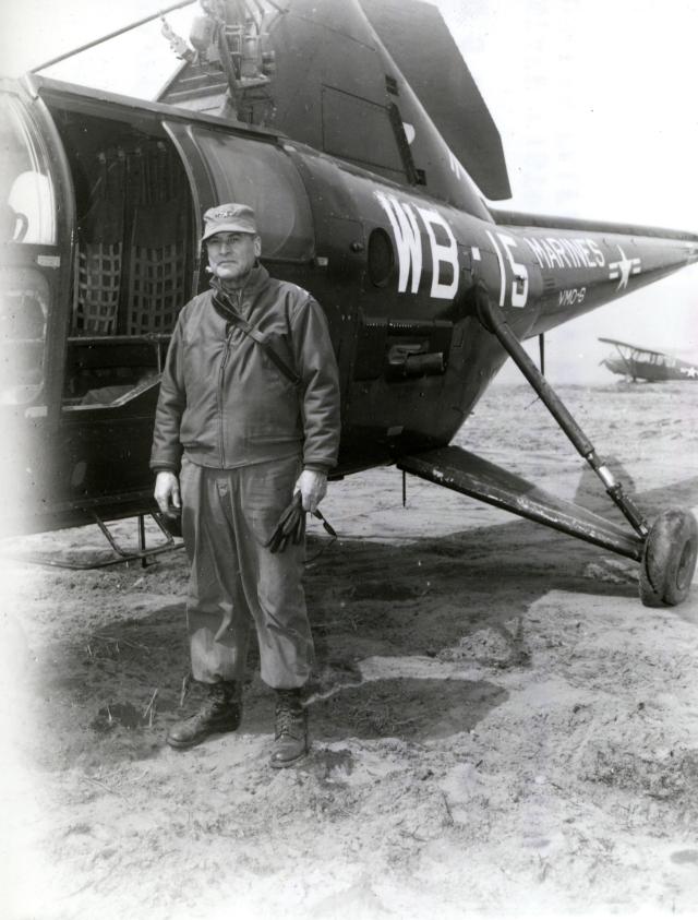 Army Major General Frank E. Lowe standing by a Marine Observation Squadron (VMO) 6 helicopter in Korea