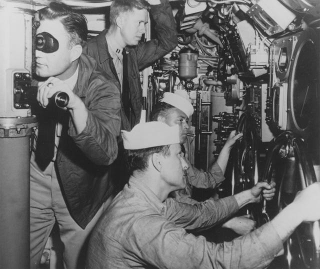 Before he was famous: Lieutenant James “Jimmy” Carter Jr. (standing, center) in the main room of the USS K-1 (SSK-1), sometime in 1952.
