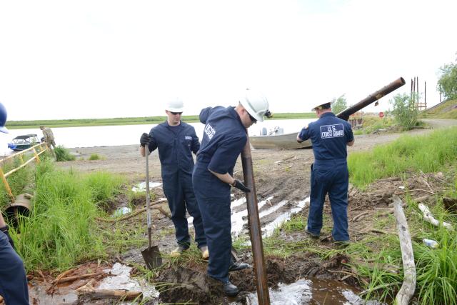 Coast Guard personnel demonstrate oil spill response tactics in Bethel, Alaska