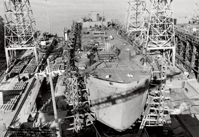 An aerial bow view of the USS Telamon (ARB-8) under construction at the Bethlehem-Hingham Shipyard during World War II. The United States was able to continually produce and replace major vessels throughout the war because of its industrial capacity.