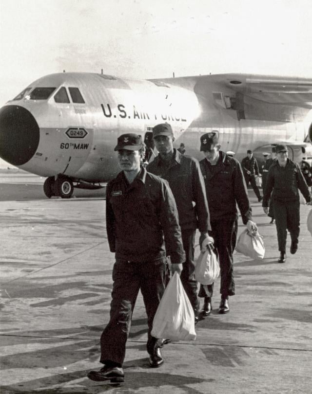 The crew of the USS Pueblo (AGER-2) disembarking from a U.S. Air Force C-141 Starlfter after their release from captivity