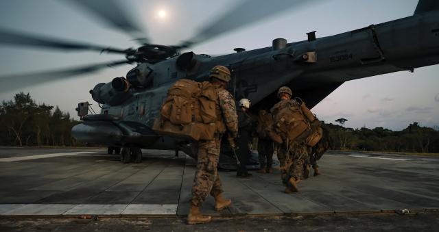 Marines from 2d Battalion, 7th Marines, board a CH-53E Super Stallion