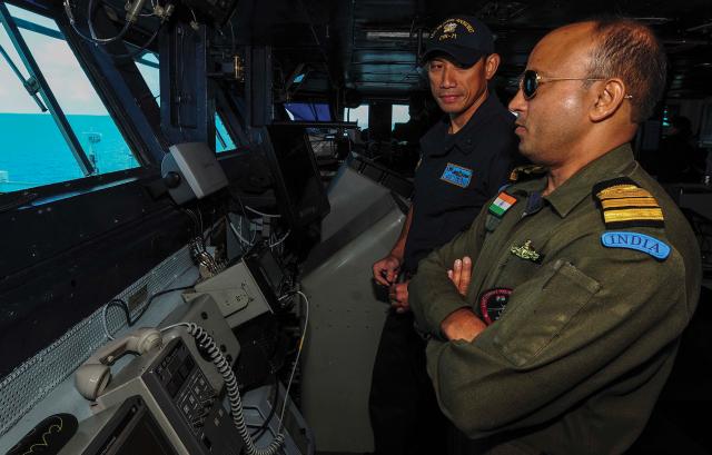 Officers of the U.S. and Indian navies speak during exercise Malabar, a biennial exercise led by the Indian Navy. In the past, Australia, India, Japan, and the United States—the members of the Quadrilateral Security Dialogue—have all participated. But the author says pressure from Beijing has kept Australia away even  as other countries have joined in from time to time.