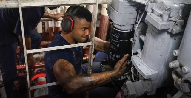 A technician works on an engine on the USCGC Stone (WMSL-758) in June 2024. 