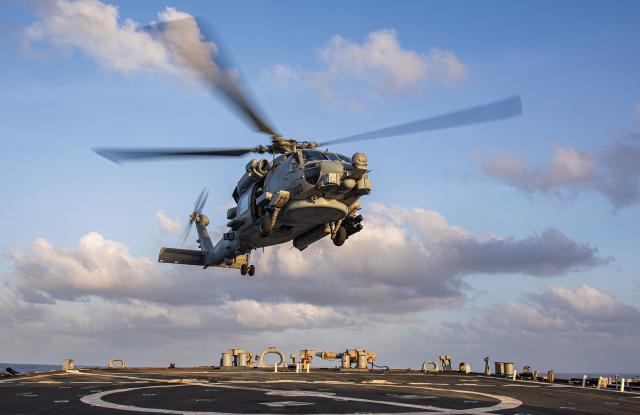 An MH-60R helicopter attached to Helicopter Maritime Strike Squadron 74 departs the flight deck of the guided-missile destroyer USS Laboon (DDG-58) in the Gulf of Aden.