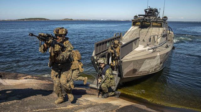 U.S. Marines with Golf Company, Battalion Landing Team 2/6, 22nd Marine Expeditionary Unit (MEU), disembark a Finnish U700 Jehu- class amphibious assault craft during an island seizure exercise on Russaro Island, Finland. 