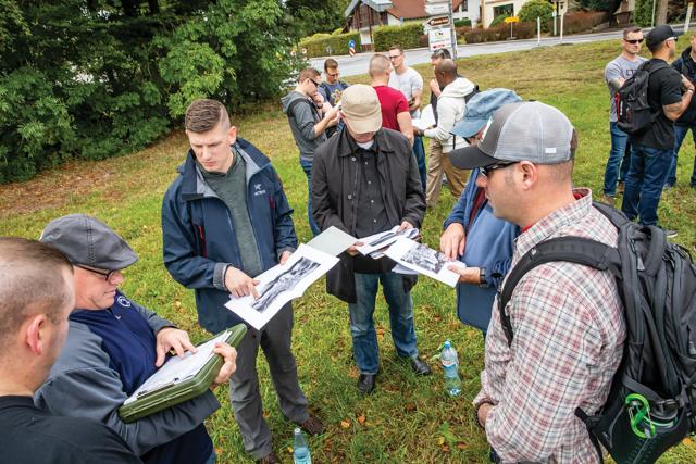 A group of soldiers looking at maps