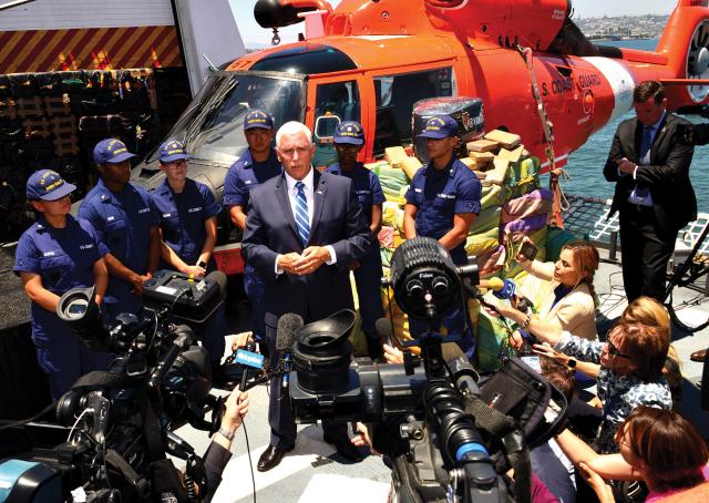 Vice President Mike Pence speaks to reporters from the deck of the USCGC Munro (WMSL-755) during a bulk offload of interdicted drugs valued at $569 million. 