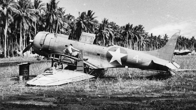 An SBD Dauntless—likely being used for parts—on the ground at Henderson Field on Guadalacanal. Functional airfields near contested areas enable sortie generation, but significant combat power and logistical support can be lost when aircraft are parked for prolonged periods and not well protected.