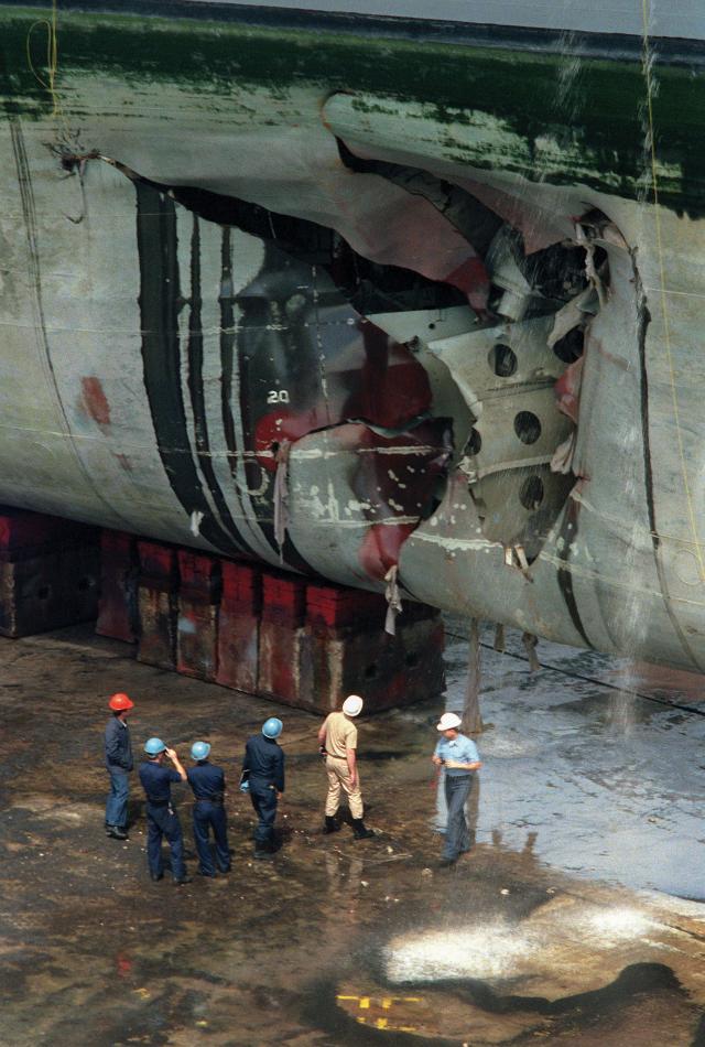 USS Tripoli (LPH-10) in drydock showing mine damage